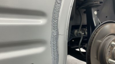 Six months after quarter-panel repair, I'm hearing a rear creak on driveway angles – what would you inspect first?